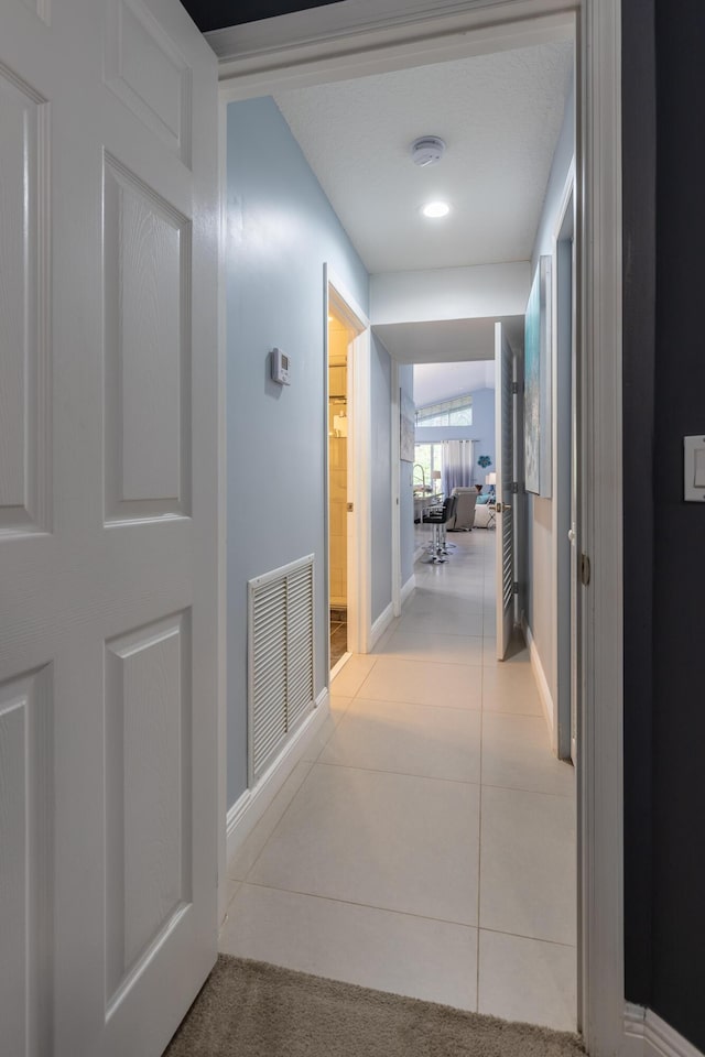 corridor featuring light tile patterned floors