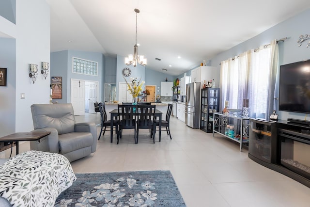 living room featuring an inviting chandelier, high vaulted ceiling, and light tile patterned flooring