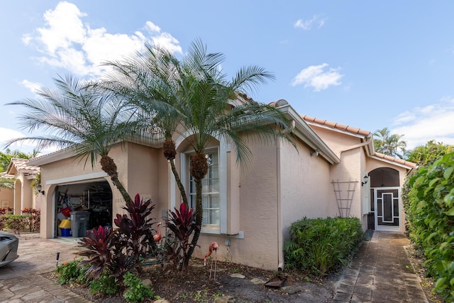 view of side of home with a garage