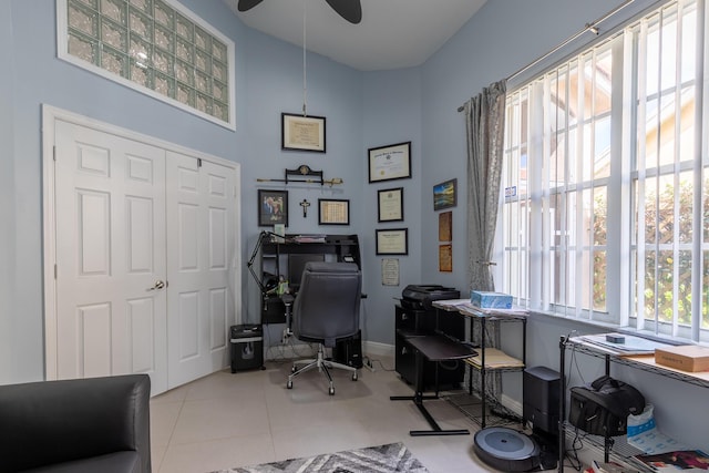 office space with light tile patterned floors, a healthy amount of sunlight, and ceiling fan