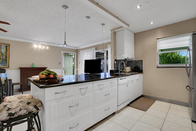 kitchen with sink, white cabinetry, hanging light fixtures, a textured ceiling, and white dishwasher