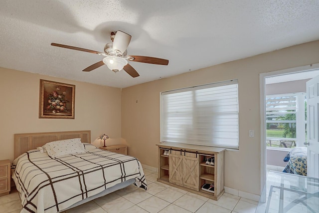 bedroom with light tile patterned floors, a textured ceiling, and ceiling fan