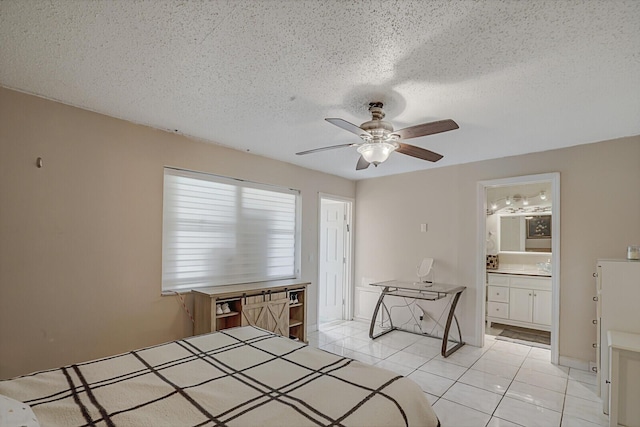 unfurnished bedroom featuring ceiling fan, light tile patterned floors, a textured ceiling, and ensuite bath