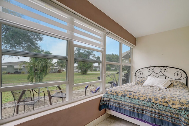 tiled bedroom with multiple windows