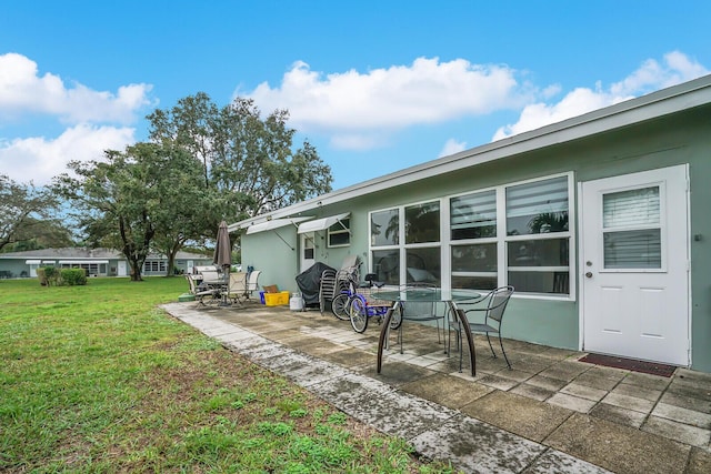 exterior space with a yard and a patio area