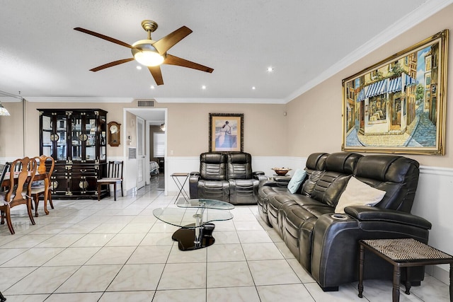 living room featuring crown molding, ceiling fan, and light tile patterned flooring