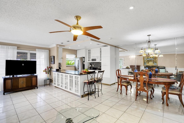 kitchen with white cabinets, stainless steel fridge, a textured ceiling, and kitchen peninsula