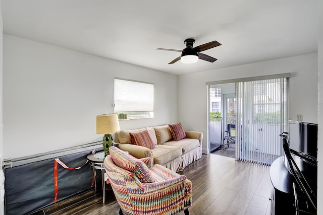 living room featuring dark hardwood / wood-style floors and ceiling fan