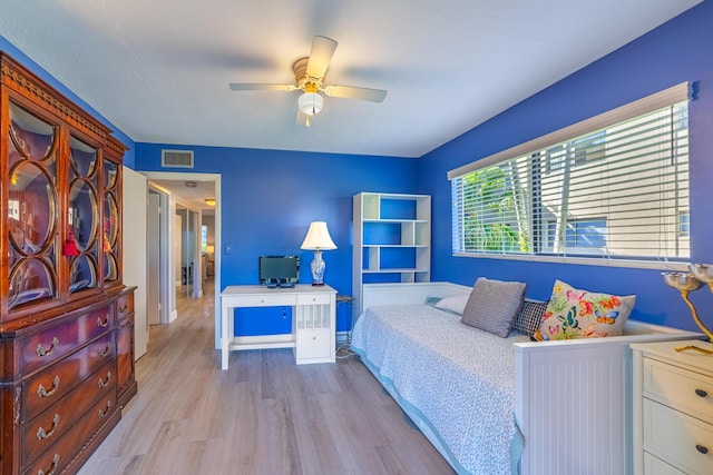 bedroom with ceiling fan and light wood-type flooring