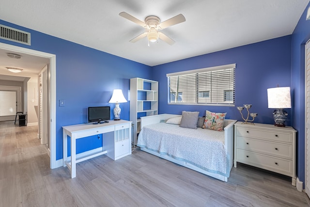 bedroom with ceiling fan and light hardwood / wood-style flooring