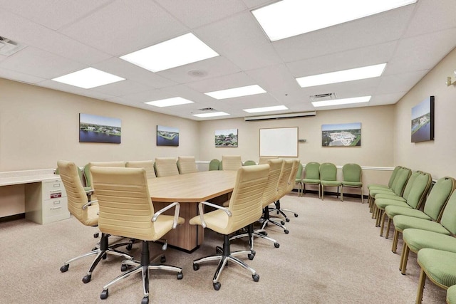 carpeted home office featuring a drop ceiling