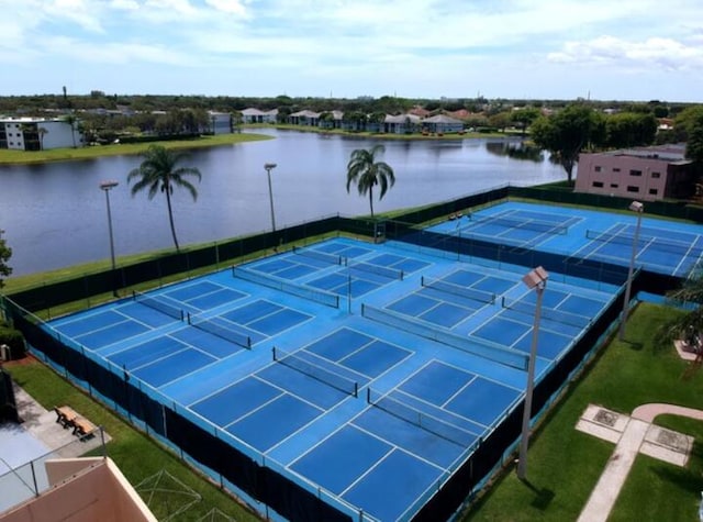 view of tennis court featuring a water view