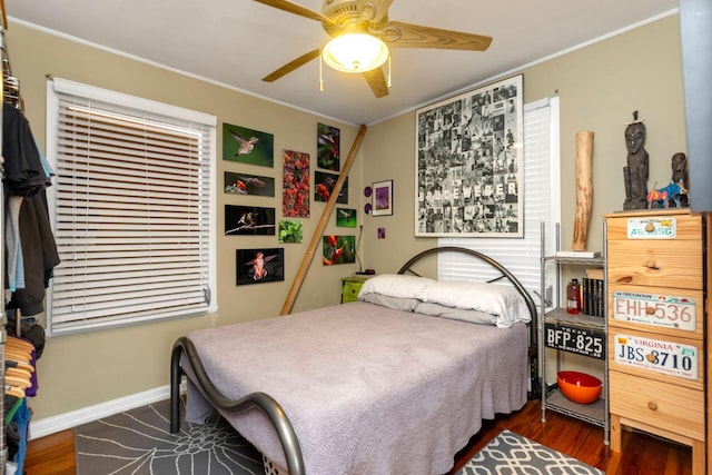 bedroom featuring crown molding, ceiling fan, and dark hardwood / wood-style floors