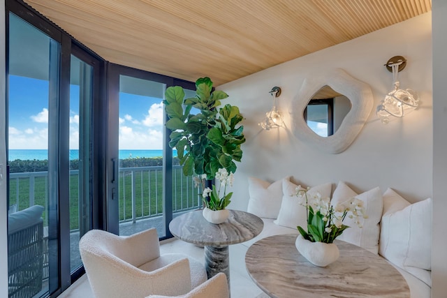 interior space with wooden ceiling and a water view