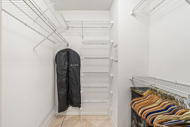 walk in closet featuring tile patterned flooring