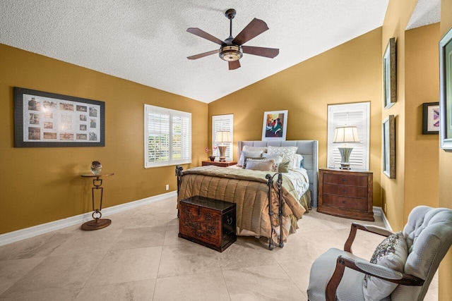 bedroom featuring vaulted ceiling, light tile patterned floors, ceiling fan, and a textured ceiling