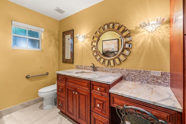 bathroom featuring tile patterned floors, vanity, and toilet