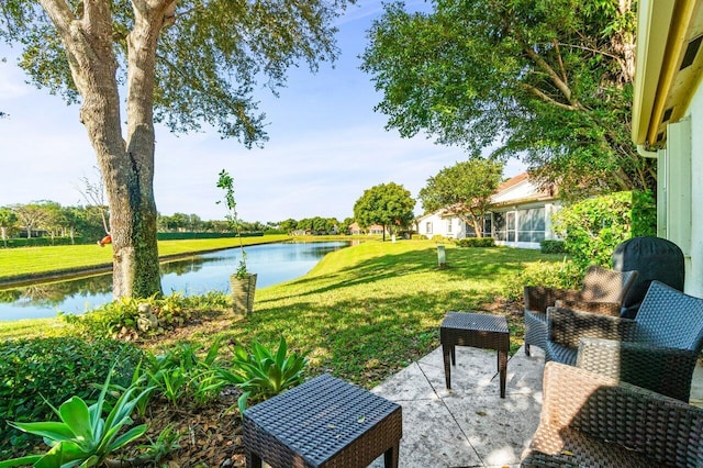 view of yard with a water view and a patio