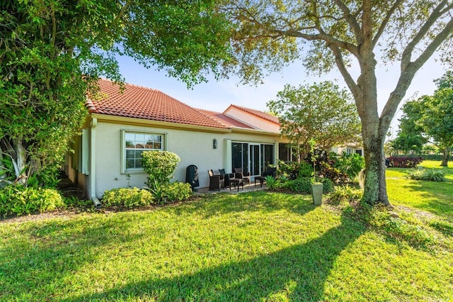 rear view of house with a yard