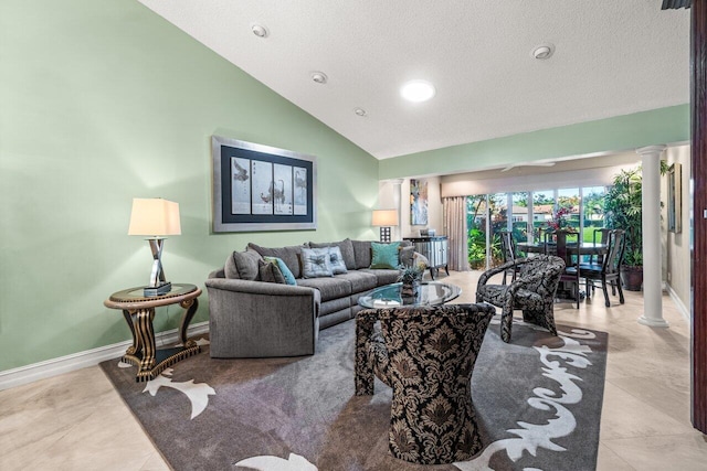 living room with high vaulted ceiling, decorative columns, and light tile patterned flooring