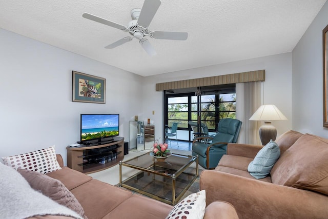 living room with ceiling fan and a textured ceiling