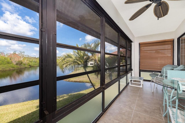 sunroom featuring a water view and ceiling fan