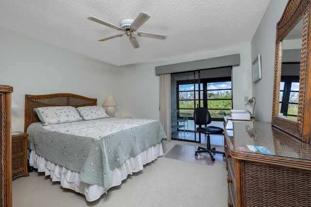 carpeted bedroom featuring ceiling fan, a textured ceiling, and access to outside