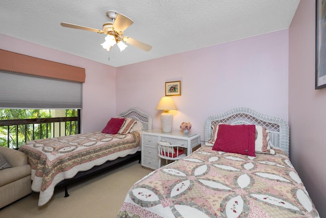 bedroom featuring ceiling fan, carpet flooring, and a textured ceiling