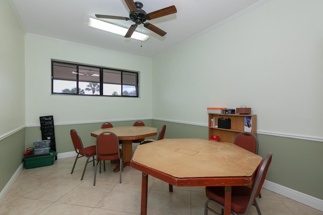 tiled dining room featuring crown molding and ceiling fan