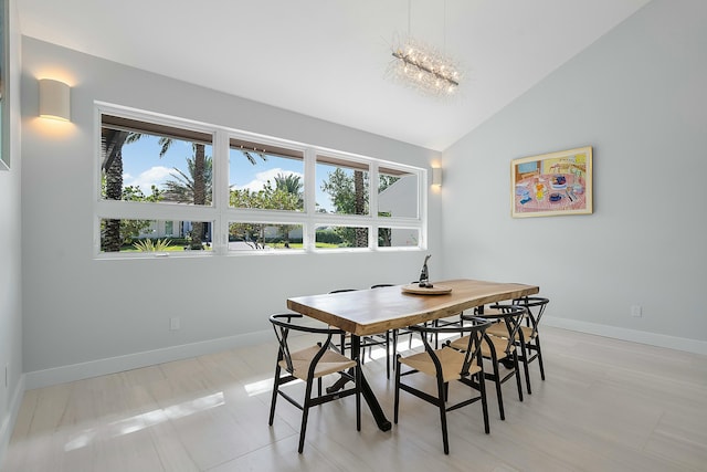 tiled dining area featuring vaulted ceiling and a chandelier