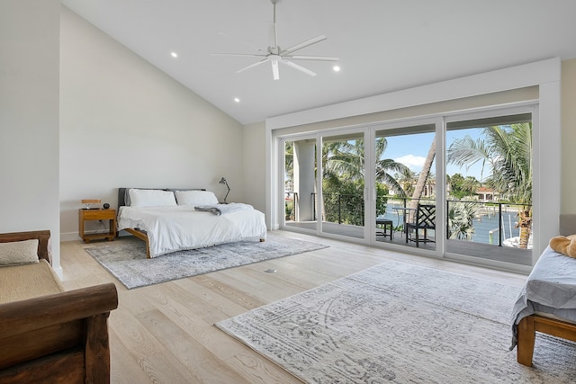 bedroom with a water view, high vaulted ceiling, ceiling fan, access to exterior, and light hardwood / wood-style floors