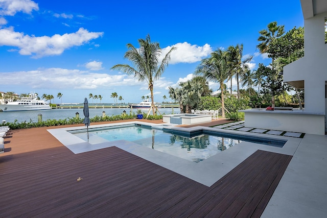 view of swimming pool featuring a hot tub and a deck with water view