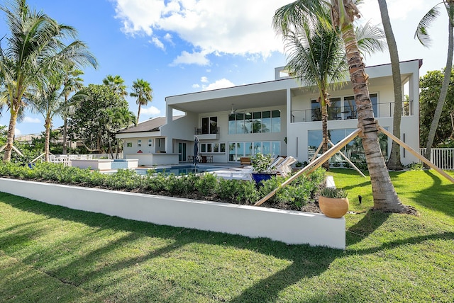 back of house with a yard, a patio area, and ceiling fan