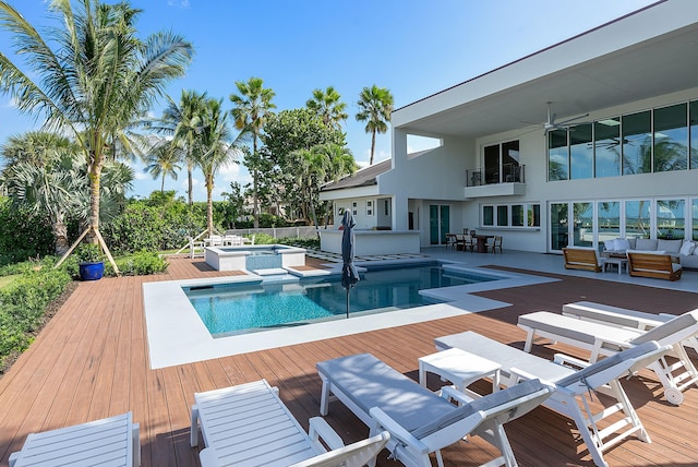 view of pool featuring an in ground hot tub, a wooden deck, an outdoor hangout area, and ceiling fan