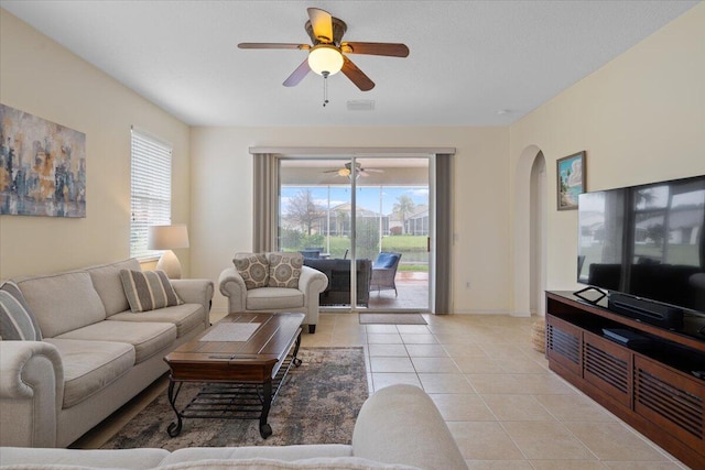 living room featuring light tile patterned floors and ceiling fan