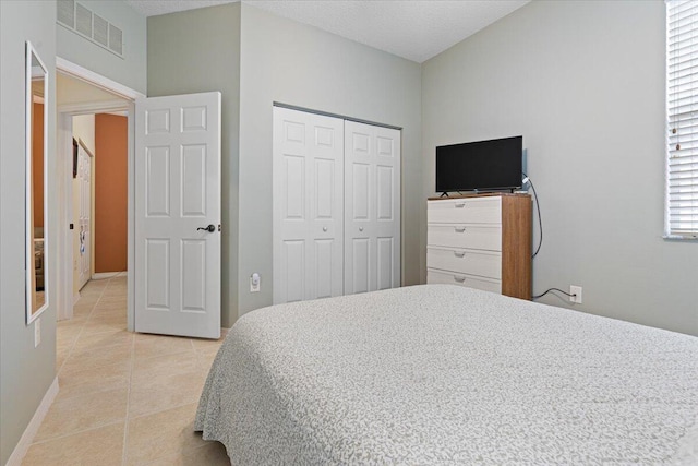 tiled bedroom featuring a closet