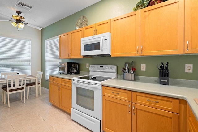 kitchen with ceiling fan, light tile patterned floors, and white appliances