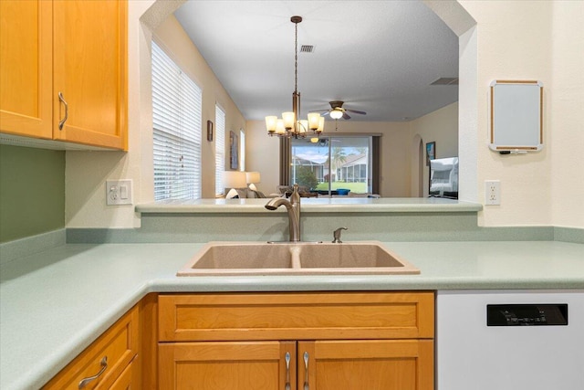 kitchen with sink, dishwashing machine, and a chandelier