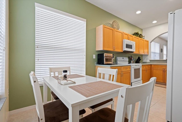 kitchen featuring white appliances and light tile patterned flooring