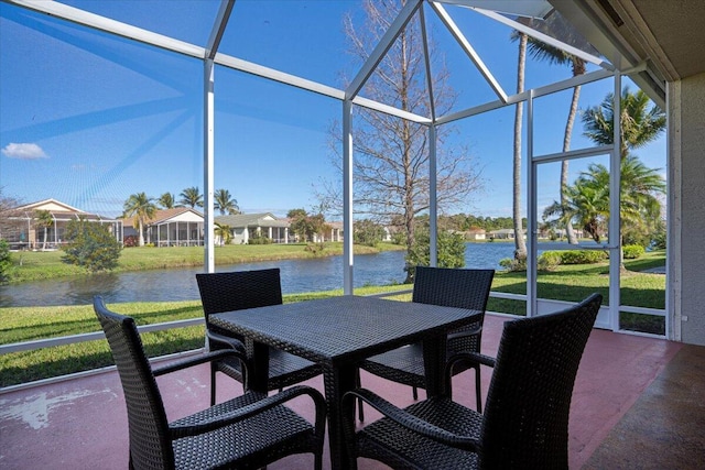 sunroom / solarium with a water view and a healthy amount of sunlight