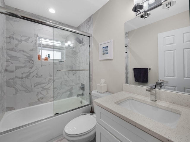 full bathroom with vanity, toilet, and bath / shower combo with glass door