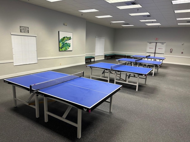 recreation room with a paneled ceiling