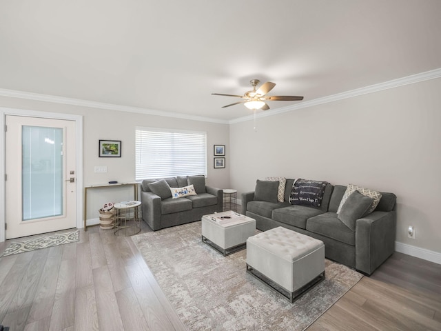 living room with hardwood / wood-style flooring, ceiling fan, and crown molding