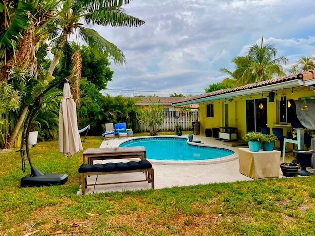 view of swimming pool featuring a patio area and a lawn