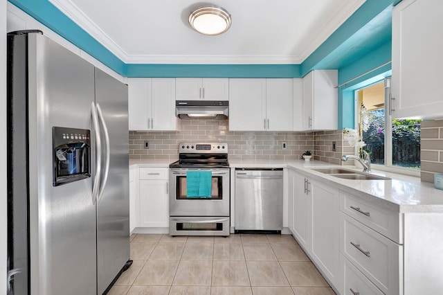 kitchen with light tile patterned flooring, sink, appliances with stainless steel finishes, decorative backsplash, and white cabinets