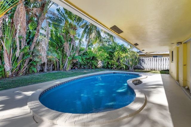 view of swimming pool featuring a fenced in pool and fence