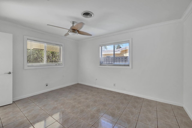 spare room with ornamental molding, a ceiling fan, visible vents, and baseboards