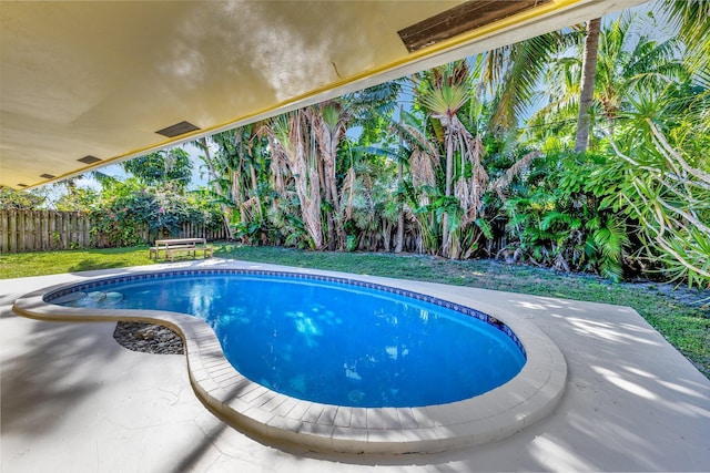 view of swimming pool featuring a fenced backyard, a lawn, a fenced in pool, and a patio