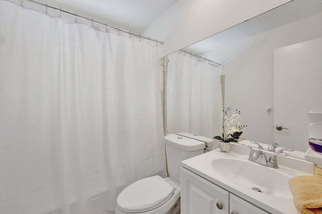 bathroom featuring walk in shower, vanity, toilet, and vaulted ceiling