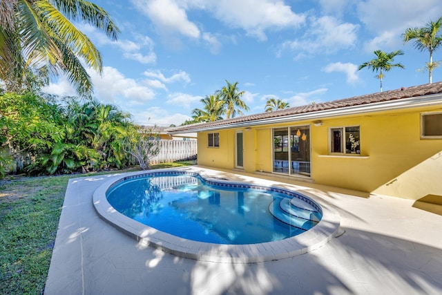 view of swimming pool with a patio, fence, and a fenced in pool